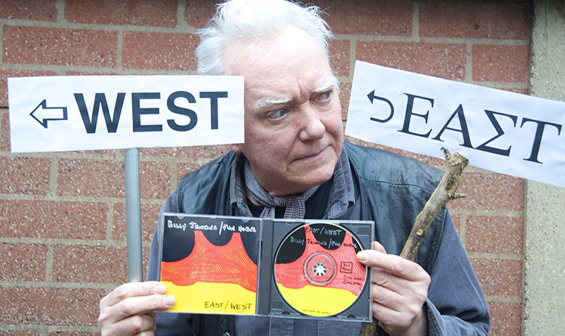 Billy Jenkins with signs pointing west. Photography by Beowulf Mayfield