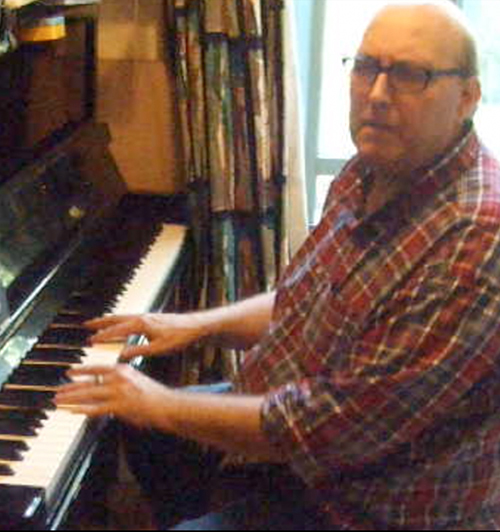 Beowulf Mayfield pictured playing the piano